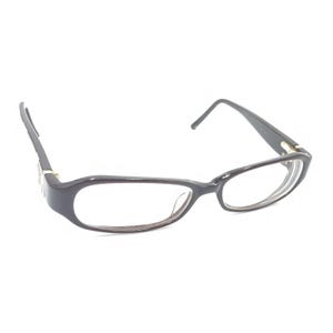 May include: Dark brown rectangular eyeglasses with a glossy finish. The frames feature thin, dark brown temples with a small metallic accent near the hinges. The clear lenses are set within a solid, dark brown plastic frame structure.
