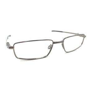 May include: A pair of rectangular eyeglasses with a thin, silver-colored metal frame. The lenses are clear, and the temples are slender and curve slightly at the ends. The glasses are set against a white background.