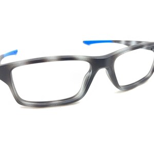 May include: Gray and blue rectangular eyeglasses with a sporty design.