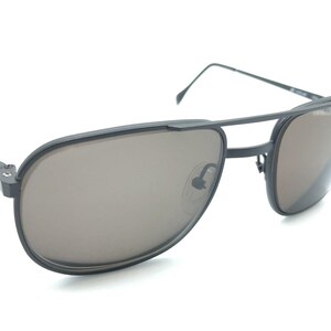 May include: Black aviator sunglasses with a metal frame and brown lenses.