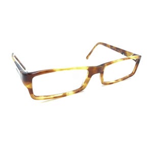 May include: Rectangular eyeglasses featuring a brown and tan tortoiseshell pattern on the frame. The glasses have thin, straight temples and a bridge connecting the two rectangular lenses, showcasing a classic design with a polished finish.