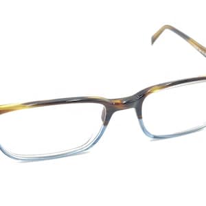 May include: Tortoise shell eyeglasses with blue tinted lenses. The frame is made of plastic and has a rectangular shape.