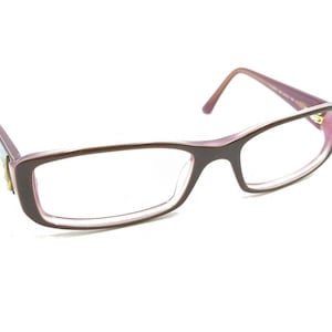May include: A pair of pink spectacles with clear lenses.