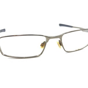 May include: Silver-toned metal eyeglasses with a rectangular frame.