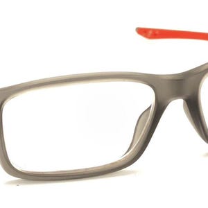 May include: Gray rectangular eyeglasses with red accents on the arms. The lenses are clear.