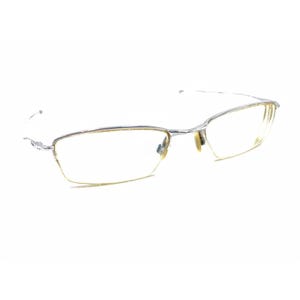 May include: Silver-toned metal eyeglasses with a rectangular frame and clear lenses.