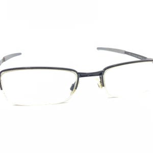 May include: Black half-rim eyeglasses with clear lenses.