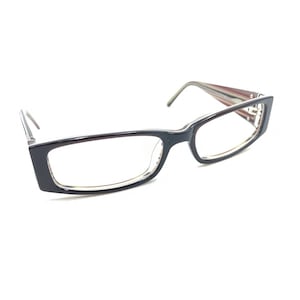 May include: Rectangular eyeglasses featuring a glossy dark brown frame with clear lenses. The temples display a subtle multi-colored striped pattern on the inner side, transitioning to a solid dark brown exterior with silver-toned metal hinges.