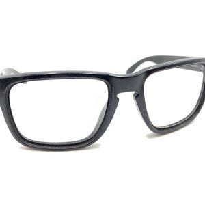 May include: Black plastic framed eyeglasses with clear lenses.
