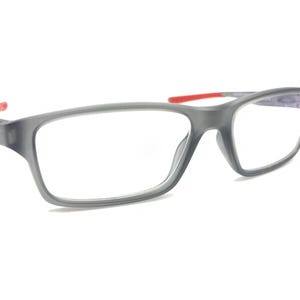 May include: Gray eyeglasses with red accents on the arms. The lenses are clear.