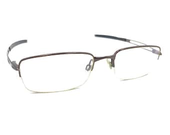 Monturas de gafas Oakley Frag OX5045-0253 de media montura en marrón pulido, 53-19, 140