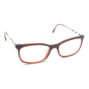 May include: Eyeglasses featuring a rectangular frame with a gradient color transition from dark brown at the top to a lighter reddish-brown at the bottom. The temples are thin and metallic, accented with a repeating black, white, and red striped pattern.