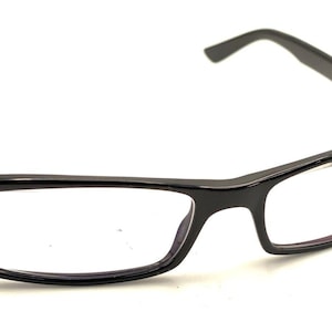 May include: Black rectangular spectacles with clear lenses.