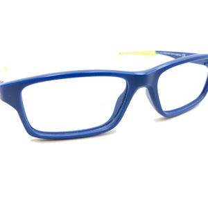 May include: Blue plastic framed eyeglasses with yellow accents on the arms.