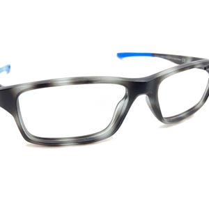 May include: Gray and black rectangular eyeglasses with blue temple tips.