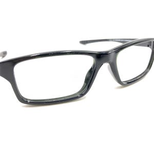 May include: Black plastic framed eyeglasses with clear lenses.