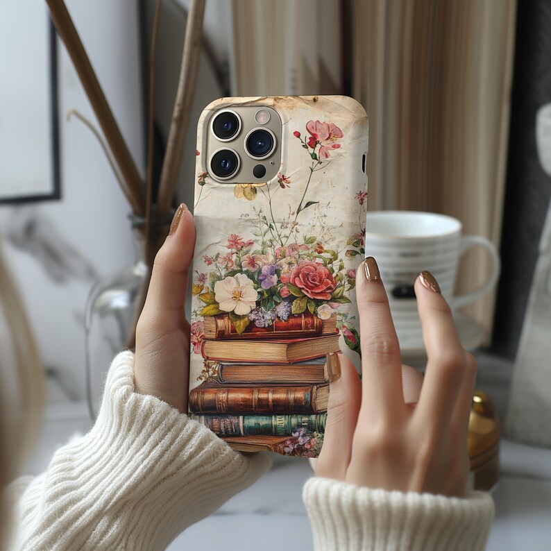 Bookish iPhone case with vintage floral design and stacked books illustration, perfect for literary girls, book lovers, readers, and cottagecore aesthetic fans; ideal graduation or sister gift.