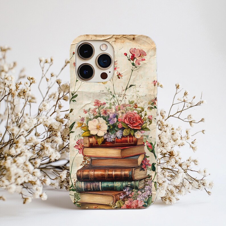 Bookish iPhone case with vintage floral design and stacked books illustration, perfect for literary girls, book lovers, readers, and cottagecore aesthetic fans; ideal graduation or sister gift.