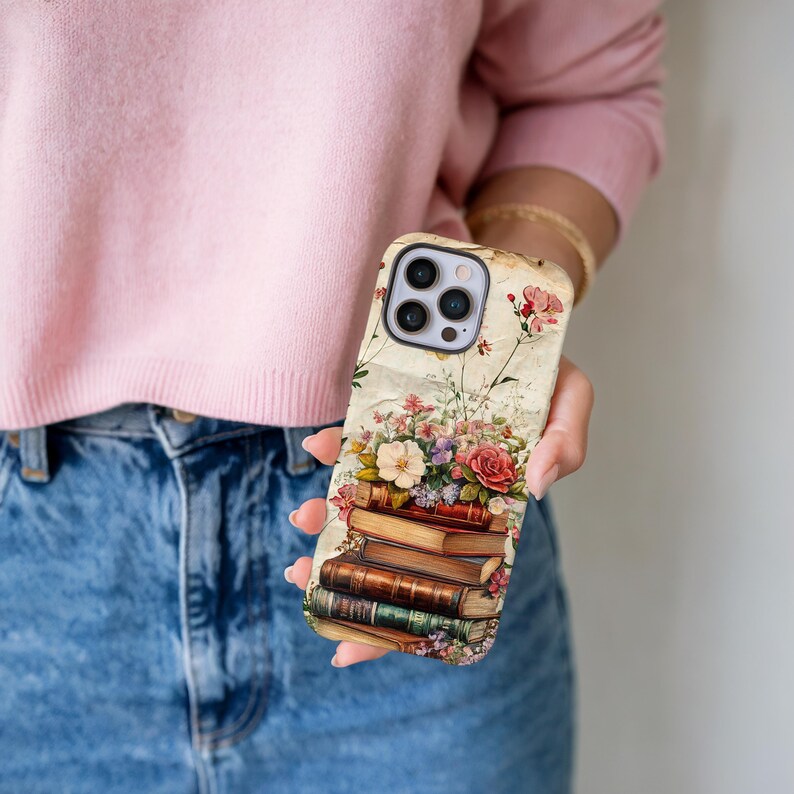 Bookish iPhone case with vintage floral design and stacked books illustration, perfect for literary girls, book lovers, readers, and cottagecore aesthetic fans; ideal graduation or sister gift.