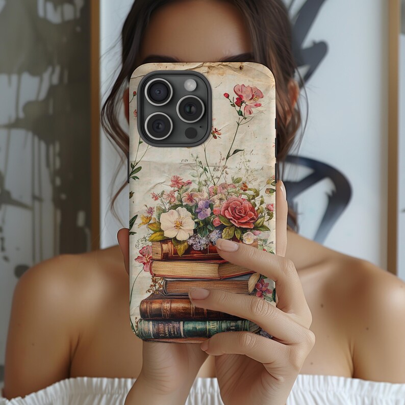 Bookish iPhone case with vintage floral design and stacked books illustration, perfect for literary girls, book lovers, readers, and cottagecore aesthetic fans; ideal graduation or sister gift.