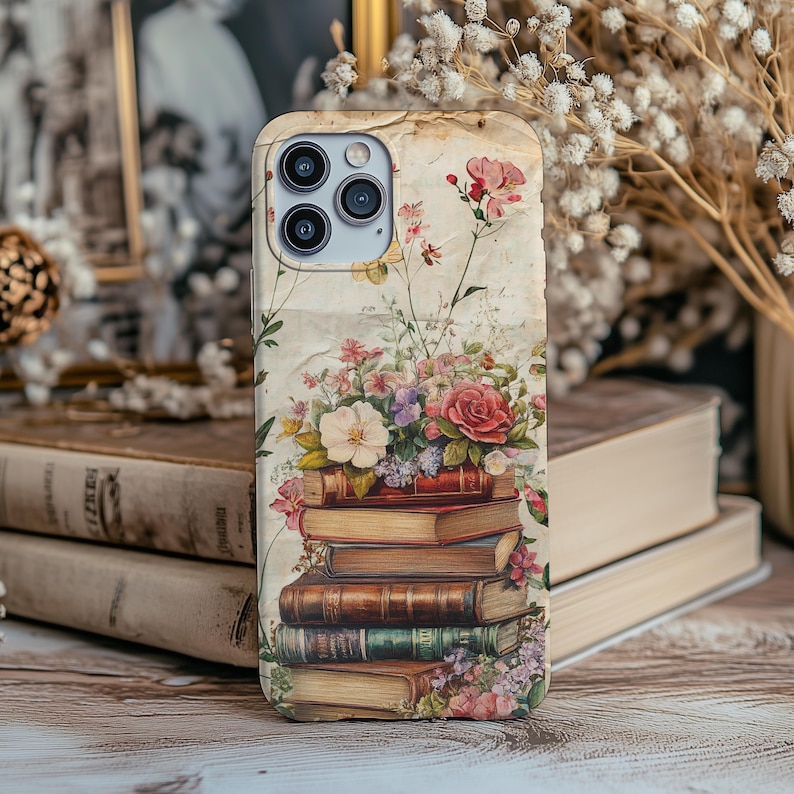 Bookish iPhone case with vintage floral design and stacked books illustration, perfect for literary girls, book lovers, readers, and cottagecore aesthetic fans; ideal graduation or sister gift.