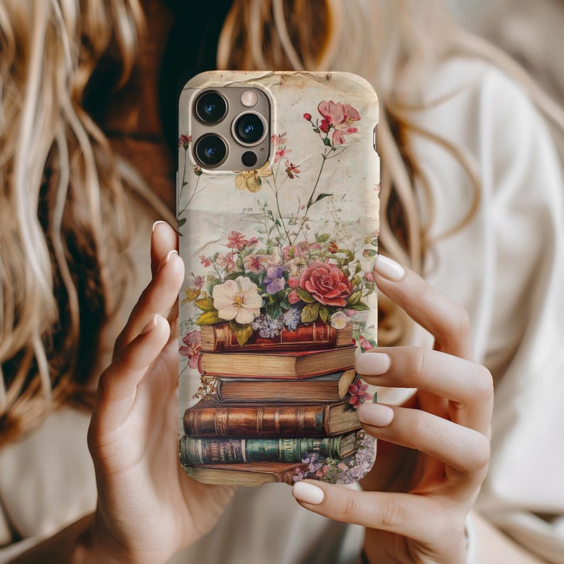 Bookish iPhone case with vintage floral design and stacked books illustration, perfect for literary girls, book lovers, readers, and cottagecore aesthetic fans; ideal graduation or sister gift.