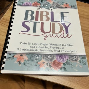 May include: A spiral-bound Bible Study Guide with a floral design in shades of pink, purple, and blue. The title "BIBLE STUDY guide" is prominently displayed. Additional text includes Psalm 23, Lord's Prayer, and other biblical references.