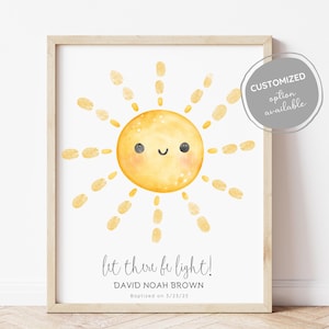 May include: A printable sun with a smiling face and rays of light. The text "Let there be light!" is below the sun, followed by "David Noah Brown" and "Baptized on 1/23/25".