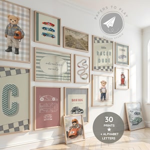 May include: A collection of framed art prints with a racing theme. The prints feature race cars, a teddy bear in a racing suit, and the text "adventure awaits" and "Little Racer Dude". The color palette includes beige, red, and blue.