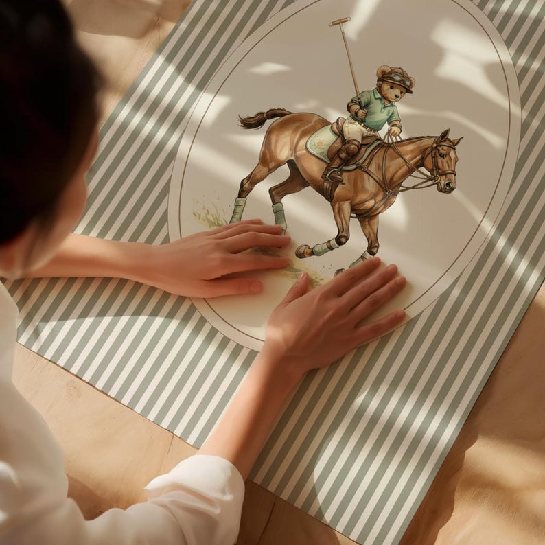 May include: An oval-shaped illustration of a teddy bear playing polo on a brown horse, set against a cream background. The bear wears a green polo shirt and riding gear. The illustration is on a striped, light green and white surface.