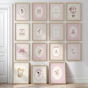 May include: A collection of framed art prints with a ballet theme. The prints feature illustrations of ballerinas, ballet shoes, bows, and a hot air balloon, in shades of pink and gold. Some prints include text such as "Little Girlhood" and "Thank Heaven for Little Girls."