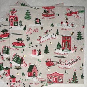 May include: A stack of Christmas-themed paper napkins with a repeating pattern. The design features red cars with Christmas trees, houses, and the text "Christmas Tree". Other text includes "Christmas Hill Thrill" and "Merry Christmas!"