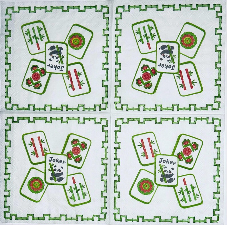 May include: Four white square paper napkins featuring a green bamboo-style border. Each napkin displays a central Joker mahjong tile with a panda illustration and the text Joker, surrounded by four other mahjong tiles with bamboo and floral motifs.