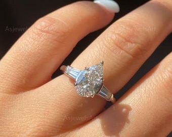 Three Stone Pear Cut Lab Grown Diamond Engagement Ring With Side Tapered Baguette Stone