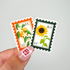 May include: Two postage stamp stickers. One orange stamp features oranges and flowers with "FL" and "45&cent;". The other green stamp shows a sunflower with "KS" and "61&cent;".