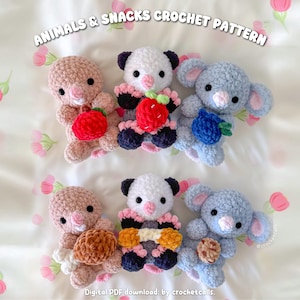 May include: Crocheted animal and snack pattern. The image shows six handmade crochet animals: two pink bunnies, two panda bears, and two blue koalas. Each animal holds a crocheted snack, such as a strawberry, blueberry, or cookie. The text "ANIMALS & SNACKS CROCHET PATTERN" is at the top.