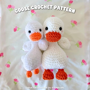 May include: Two white crochet geese with orange beaks and feet are displayed on a floral patterned background. The text "GOOSE CROCHET PATTERN" is at the top. The text "Digital PDF download: by crochetcalls." is at the bottom.