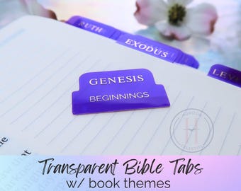 May include: Purple Bible tabs with gold lettering, including "Genesis" and "Beginnings." The tabs are on a white, lined page. The image also includes the text "Transparent Bible Tabs w/ book themes."