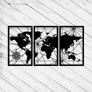May include: A three-panel black metal world map wall art. The map features a compass rose and a network of lines. The artwork is set against a white wooden background.