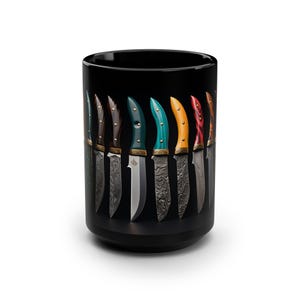 May include: A black ceramic mug with a design of ten knives with different colored handles. The knives are arranged in a row, with the handles facing the viewer. The knives are all the same size and shape, but the handles are different colors. The mug is on a white background.