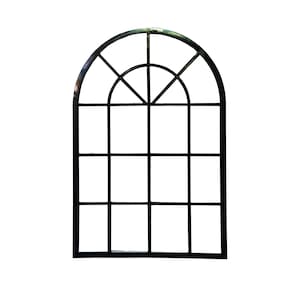 May include: Black metal arched window frame with a grid pattern. The top section has a semi-circular design with radiating lines, while the lower section has a rectangular grid. The frame is a decorative element.