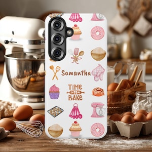 May include: White phone case with a baking theme, featuring cupcakes, donuts, and kitchen tools. The name "Samantha" and the phrase "Time to Bake" are printed on the case. The case has a camera cutout.