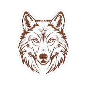 May include: A brown and white sticker featuring a detailed illustration of a wolf's head. The wolf is depicted in a stylized, symmetrical design with intricate line work, showcasing its fur, eyes, and facial features. The sticker has a white border.