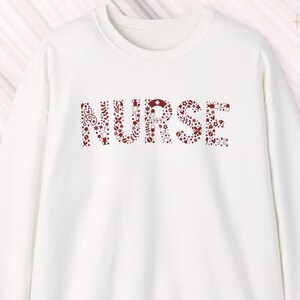 Nurse Sweatshirt: Featuring a red pattern 50% cotton/polyester sizes S-3X