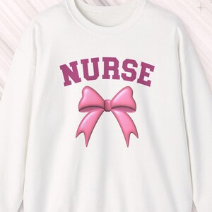 Pink Nurse Bow Sweatshirt: 50% cotton/polyester sizes S-3X