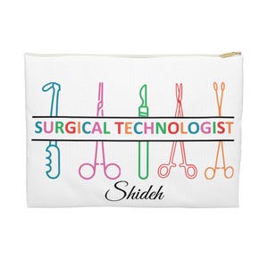 May include: White zippered pouch with a colorful illustration of surgical instruments and the text "SURGICAL TECHNOLOGIST" in rainbow colors. The name "Shideh" is written in cursive below the instruments.