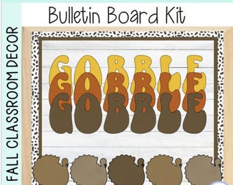 May include: A Thanksgiving themed bulletin board kit with the word "Gobble" in brown, orange, and yellow letters. The letters are layered on top of each other. There are five brown turkeys at the bottom of the board.