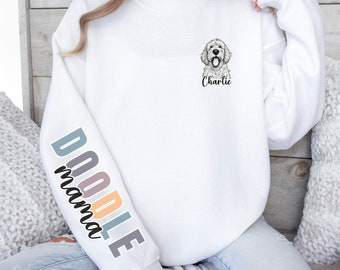 May include: White sweatshirt with a doodle dog graphic on the front and the text "Doodle mama" on the sleeve. The dog is named "Charlie".