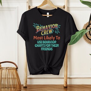 May include: Black t-shirt with a colorful graphic that says "Behavior Crew" and "Most Likely To Use Behavior Charts For Their Friends".
