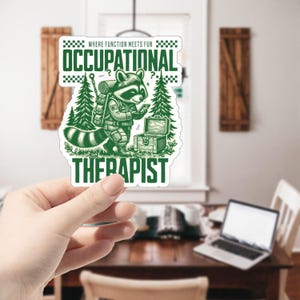 May include: A green and white sticker with a cartoon raccoon wearing a backpack and holding a phone. The text on the sticker reads "Where function meets fun Occupational Therapist".